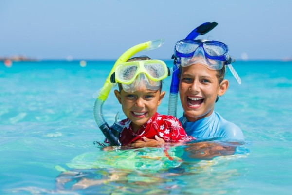 Kids snorkeling in the crystal bluw waters of the Caribbean