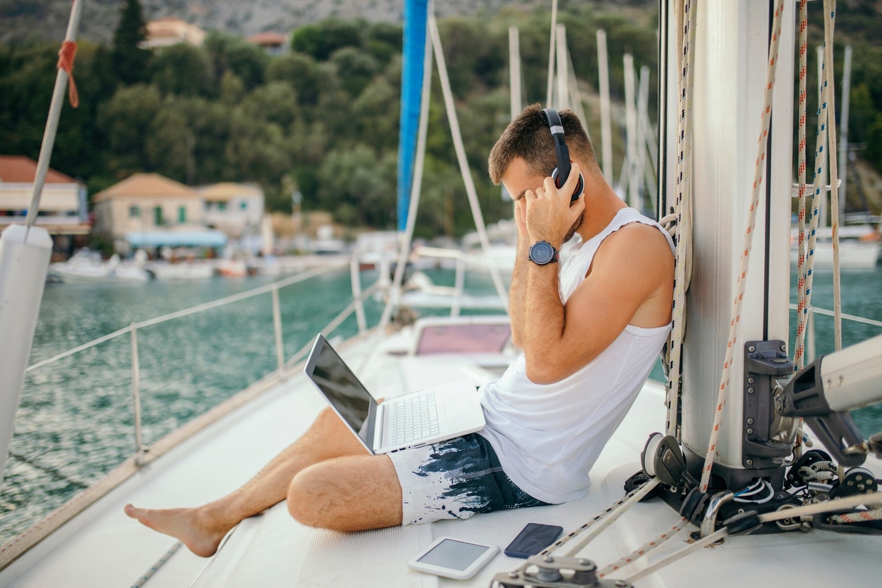 Man using his laptop aboard a private yacht charter