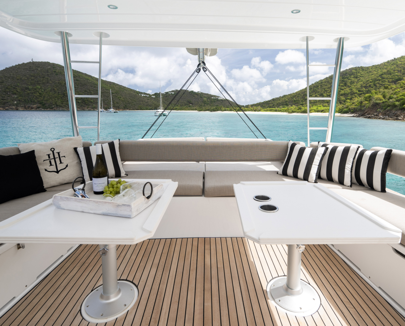 tables in the rear of a yacht in tropical water